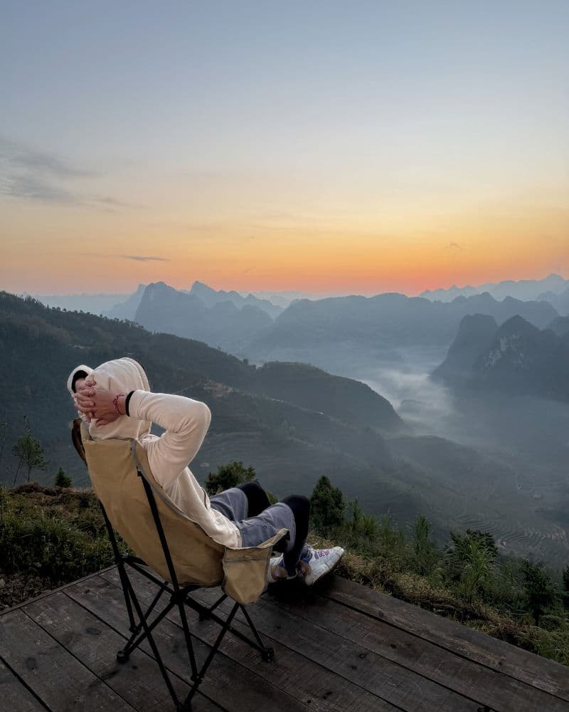 A sea of clouds filling the valleys between the mountains of Ha Giang at sunrise